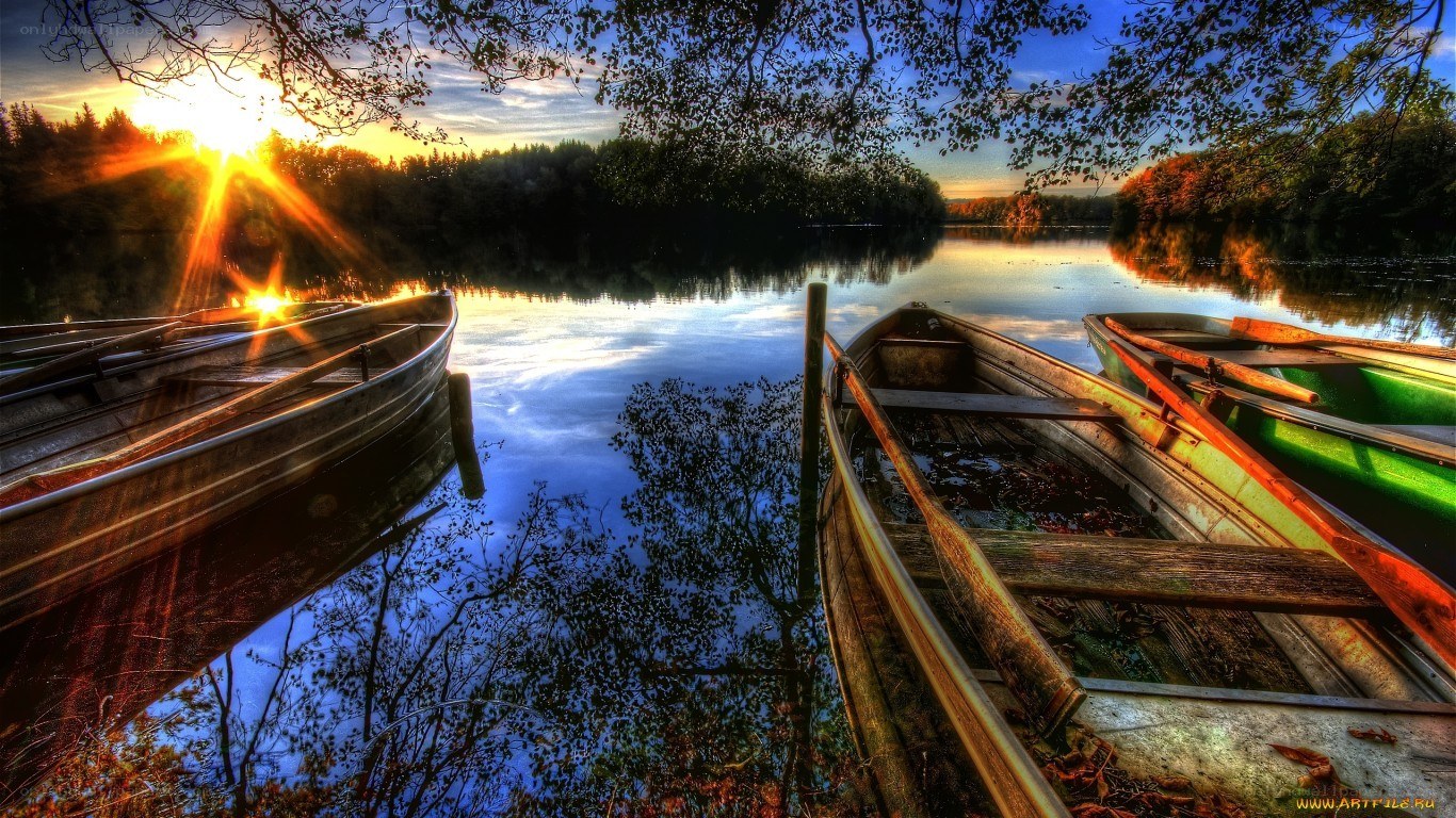 Sunset boats on a calm lake