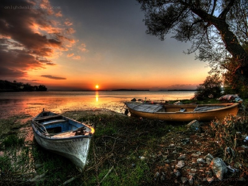 Sunset by the lake with boats