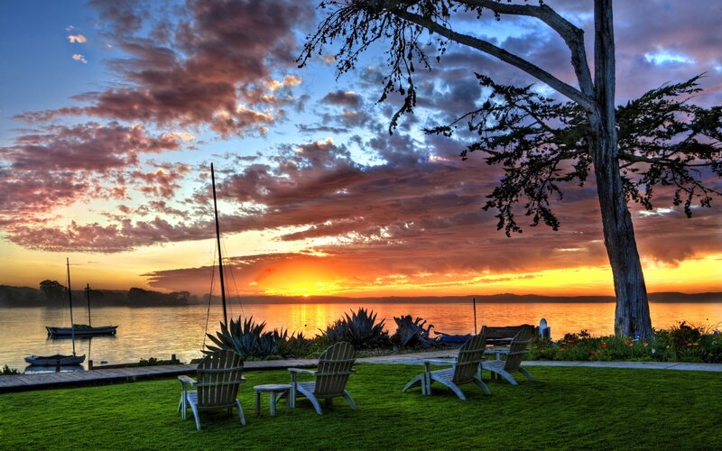 Sunset by the lake with chairs