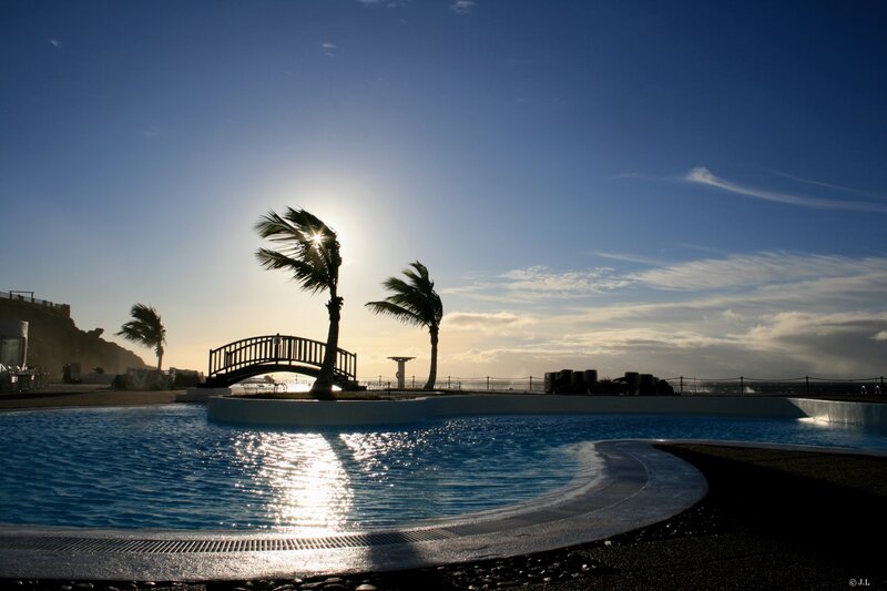 Sunset by the pool with palm trees