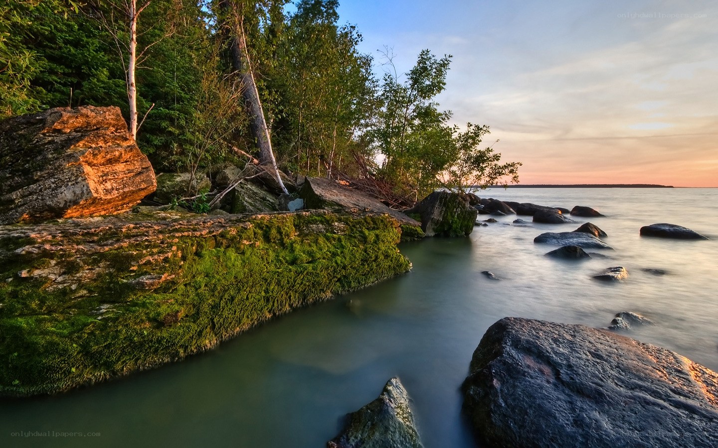 Sunset by the rocky shore