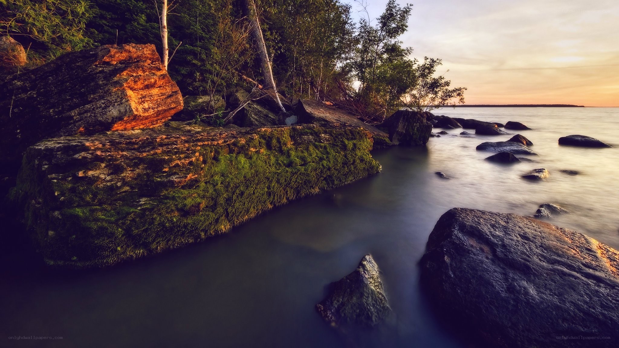 Sunset by the rocky shore