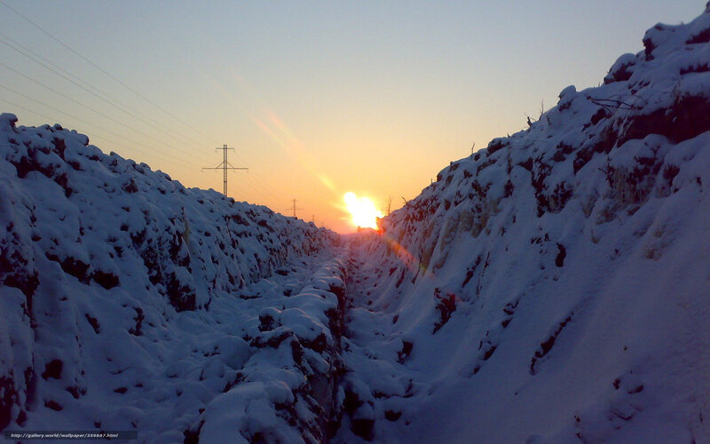 Sunset in a snowy trench
