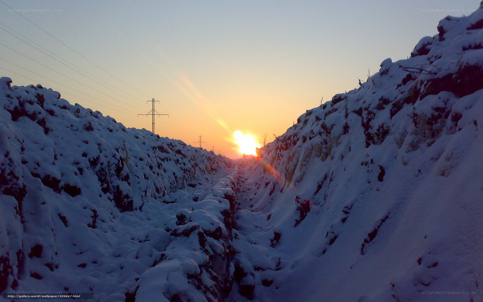 Sunset in a snowy trench