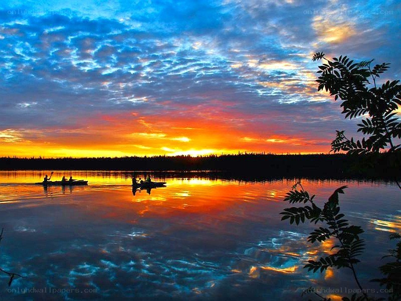 Sunset kayaking on a calm lake