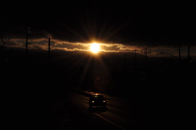 Sunset on a dark road