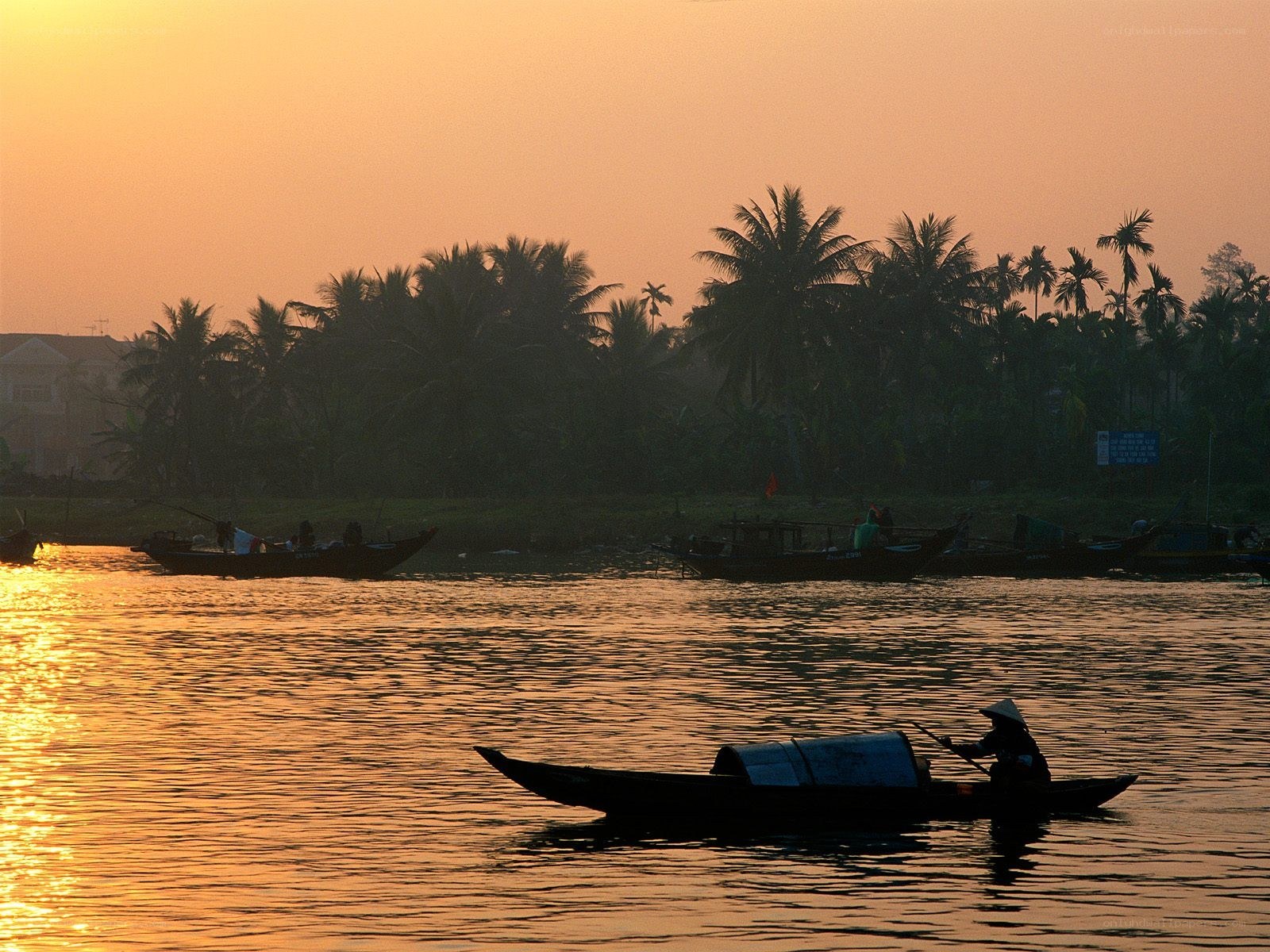 Sunset on a river with boats