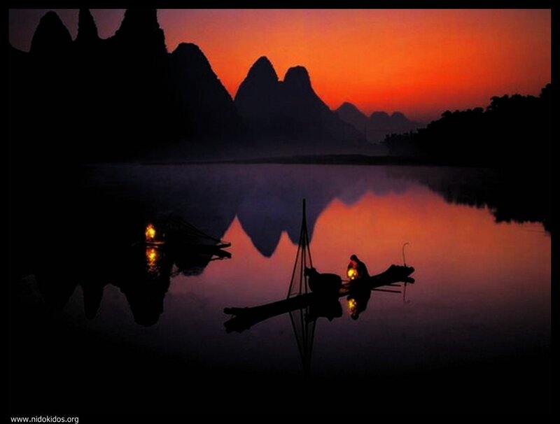 Sunset on a river with boats