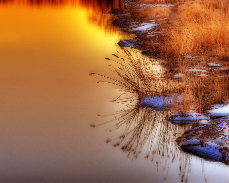 Sunset on a snowy riverbank