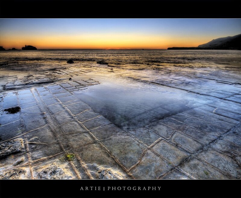 Sunset on a tiled beach