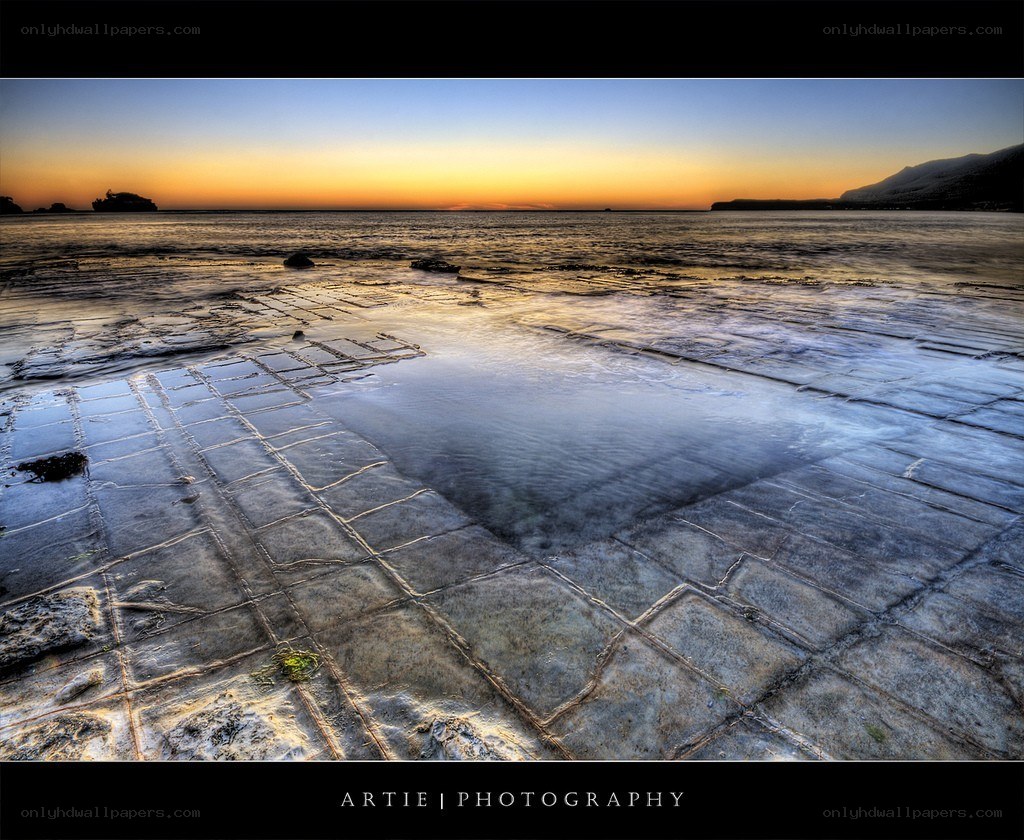 Sunset on a tiled beach
