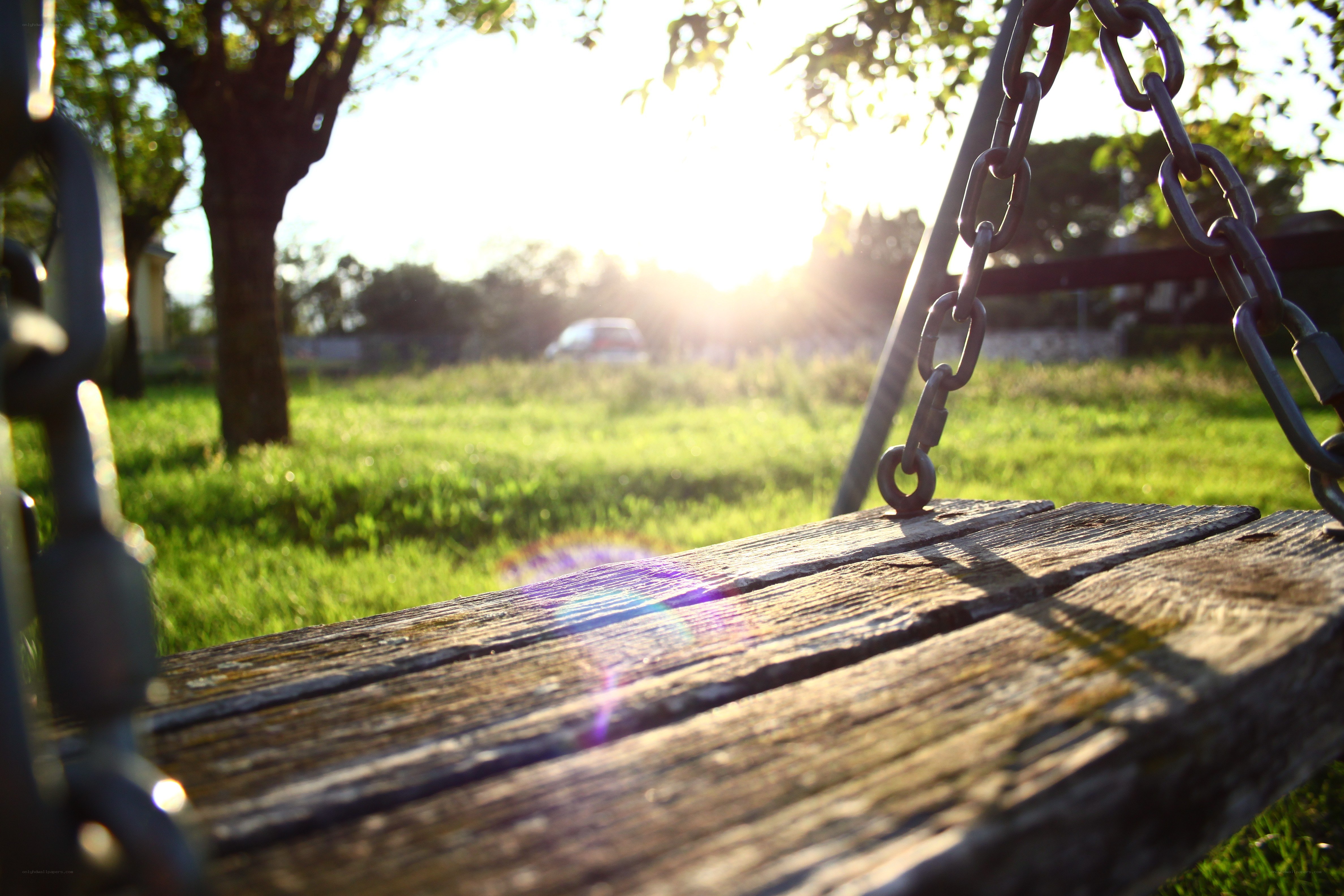 Sunset on a wooden swing