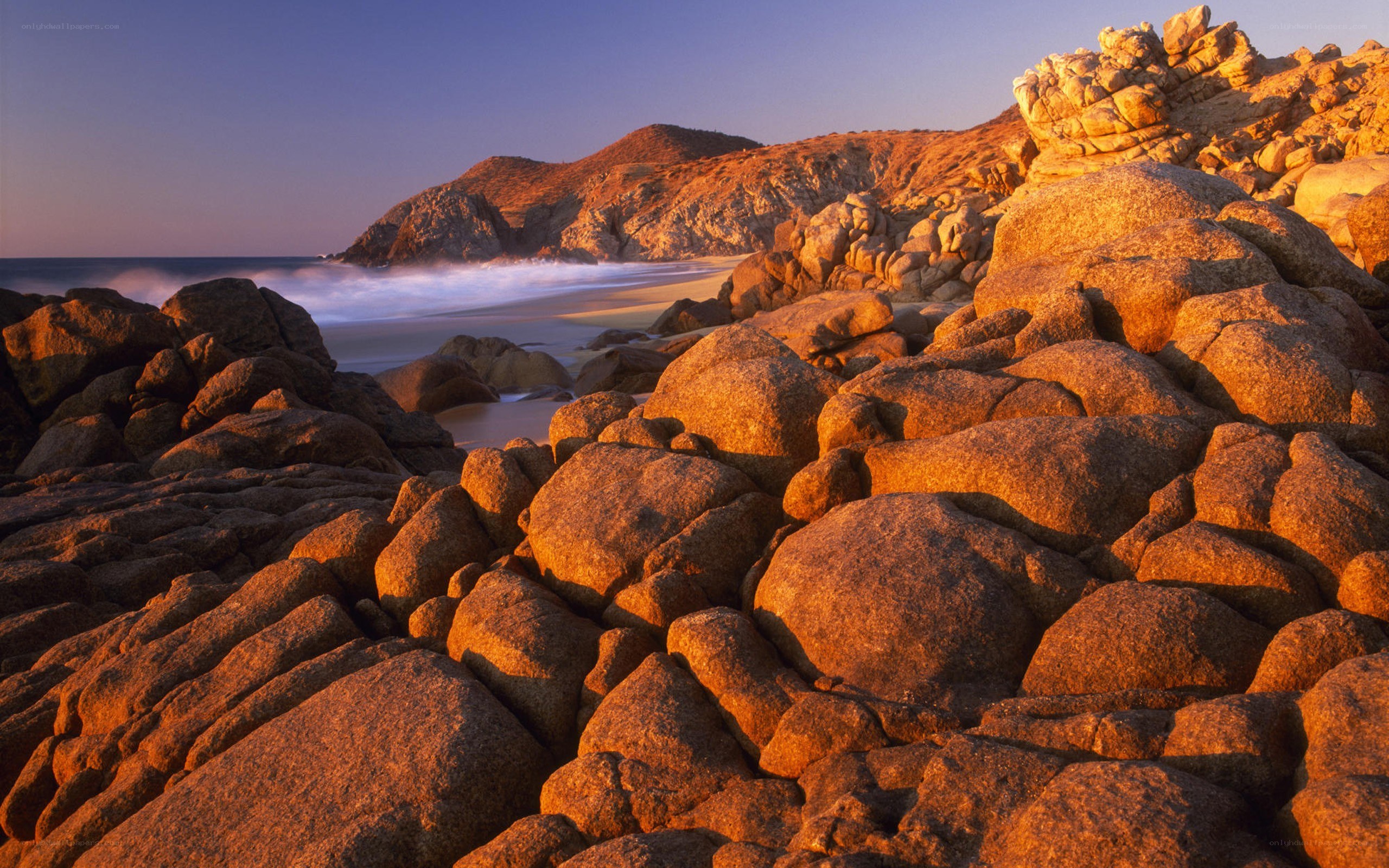 Sunset on rocky beach