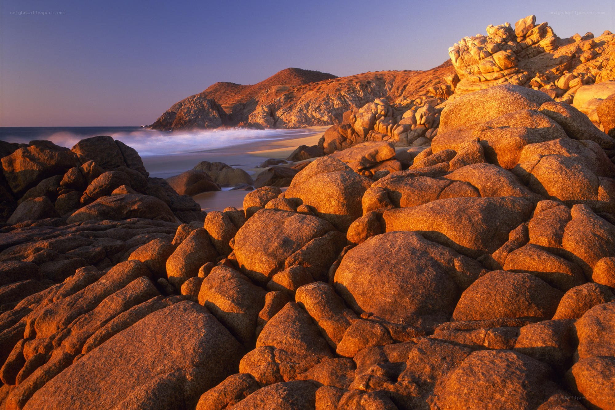 Sunset on rocky beach
