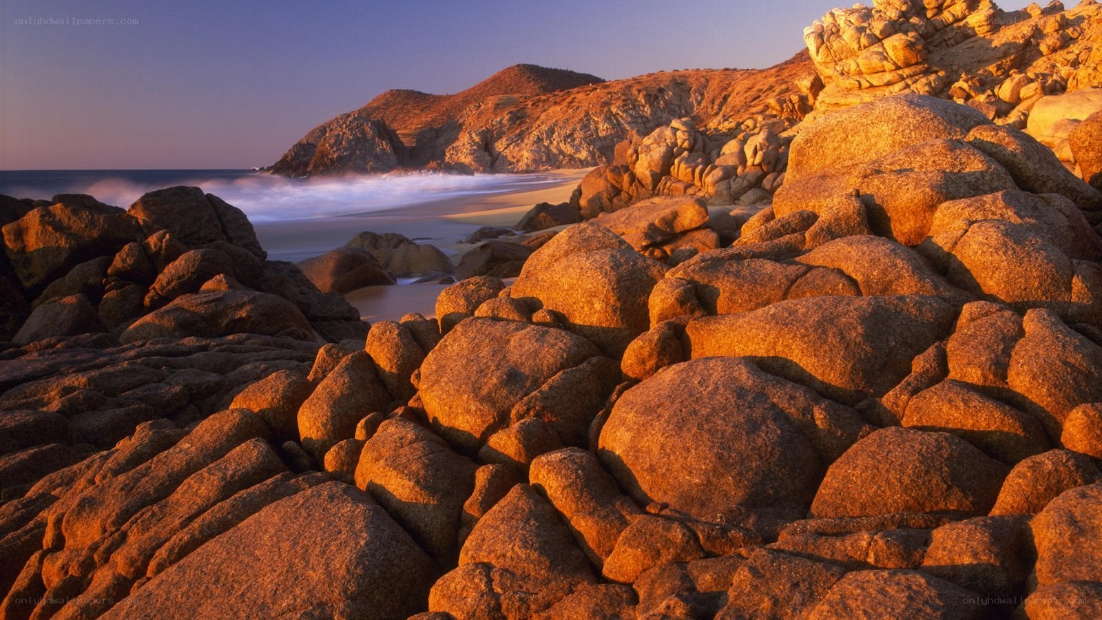 Sunset on rocky coastline