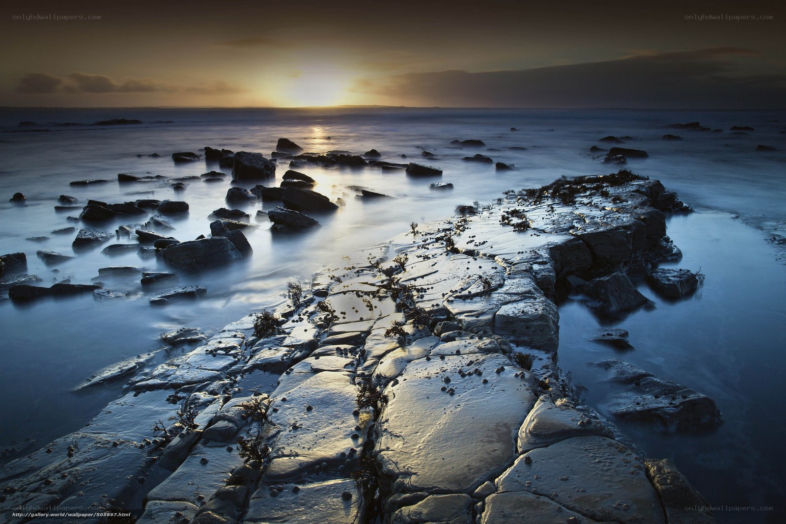 Sunset on rocky shoreline