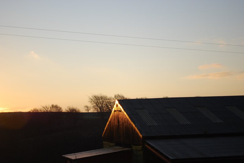 sunset over a barn