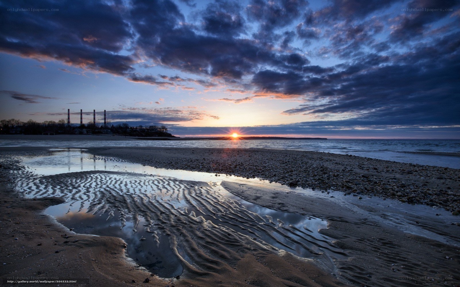 Sunset over a beach with ripples