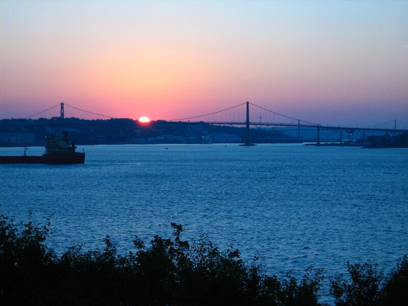 Sunset over a bridge and ship