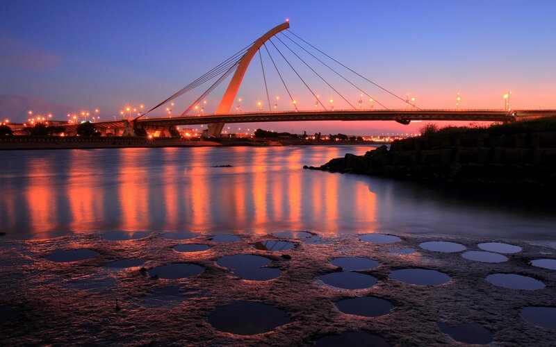 sunset over a cable-stayed bridge