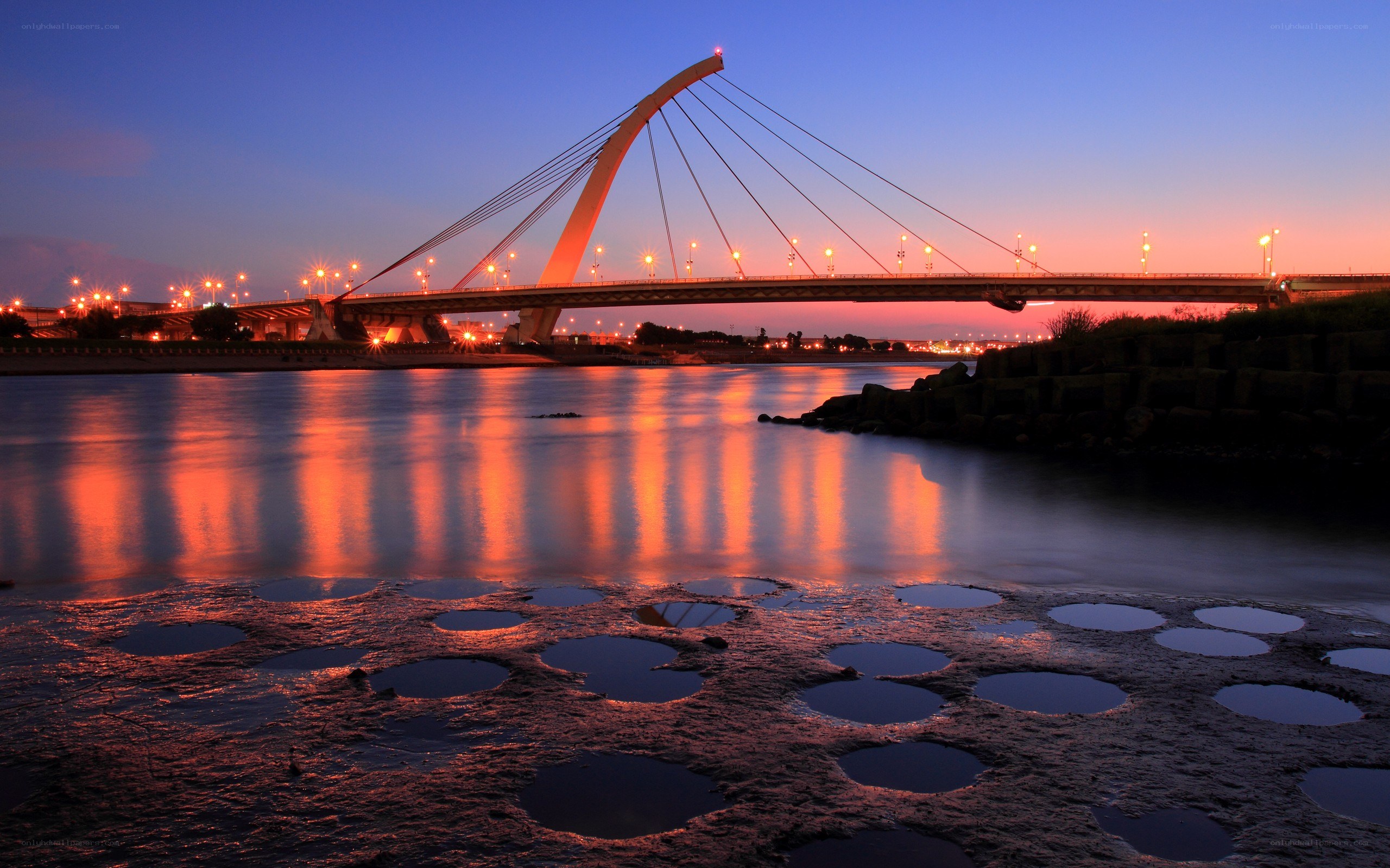 sunset over a cable-stayed bridge