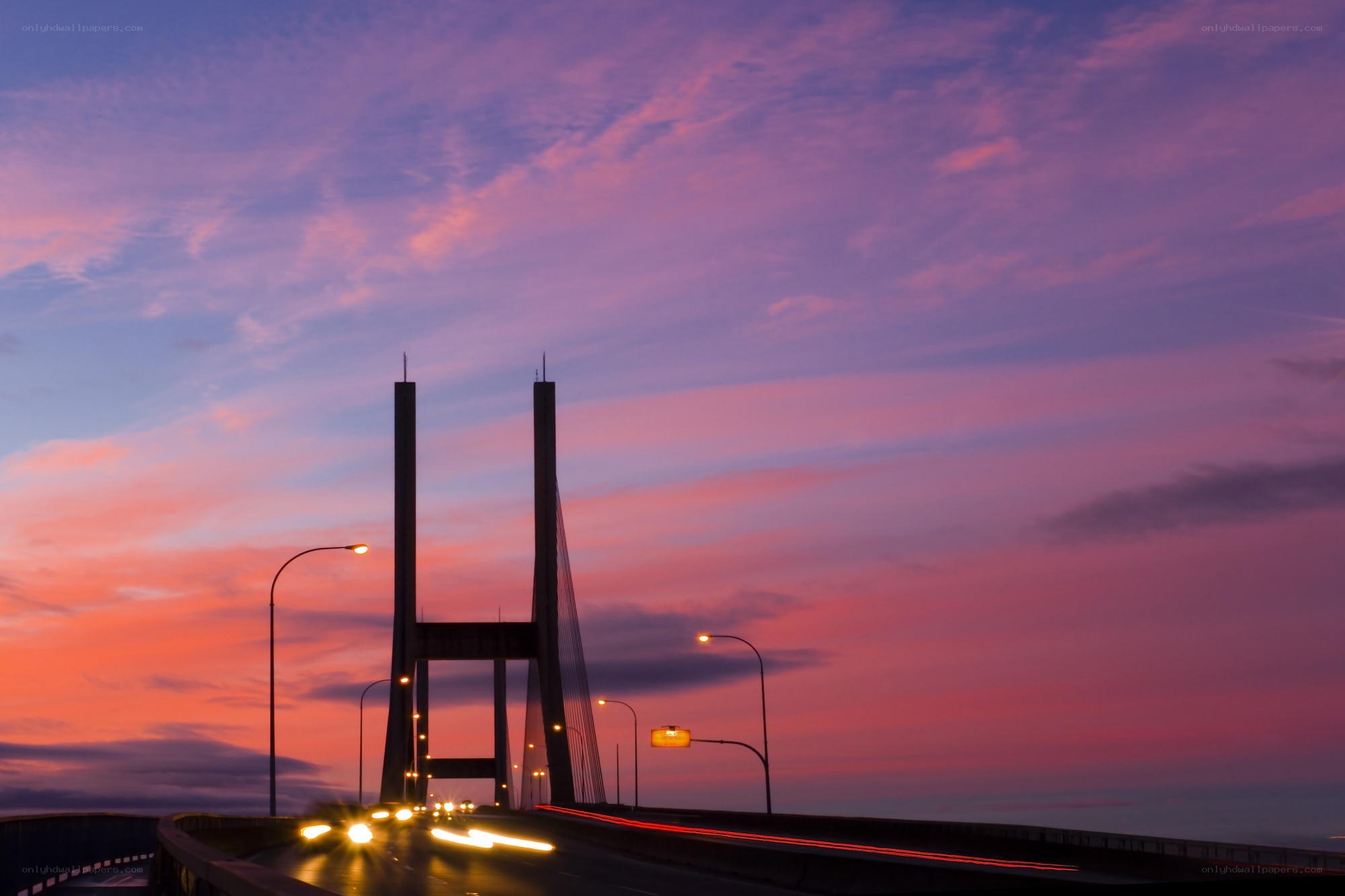 sunset over a cable-stayed bridge