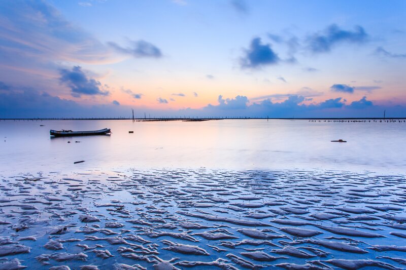 Sunset over a calm coastal bay