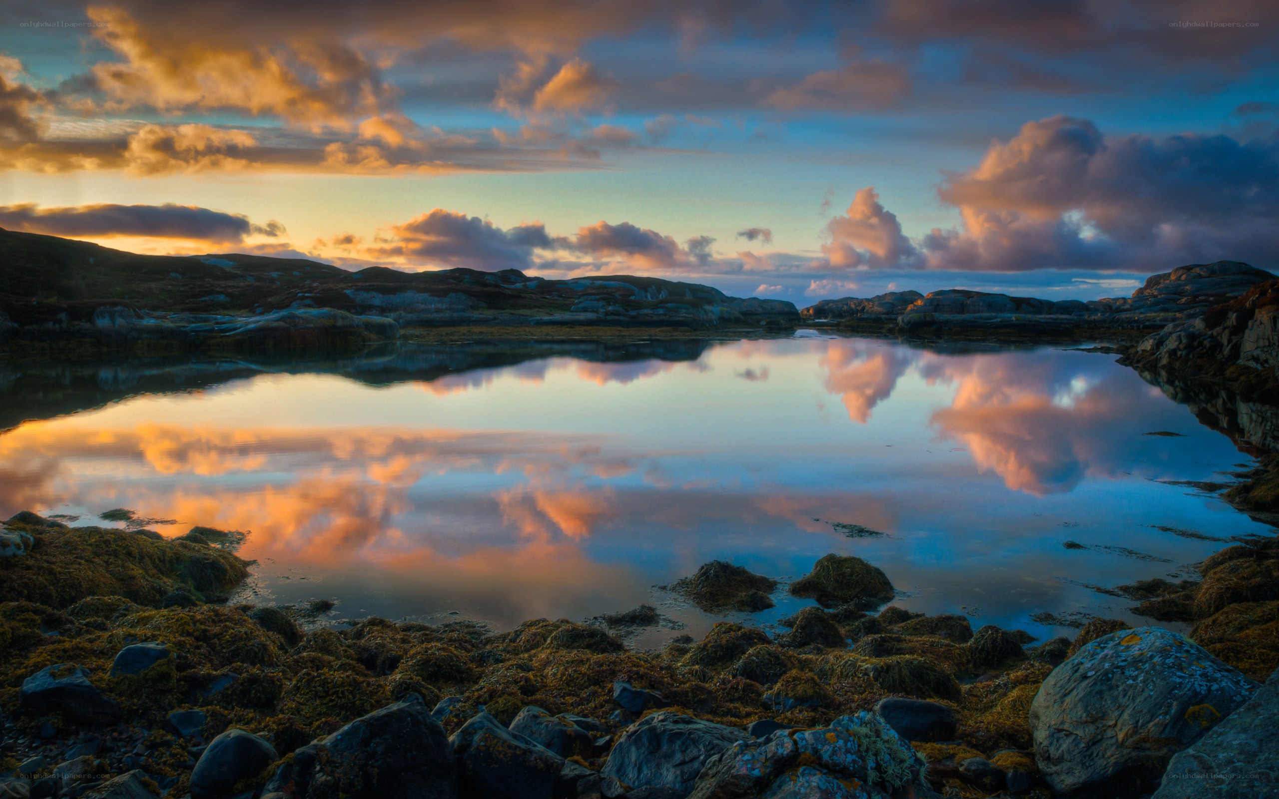 Sunset over a calm coastal inlet