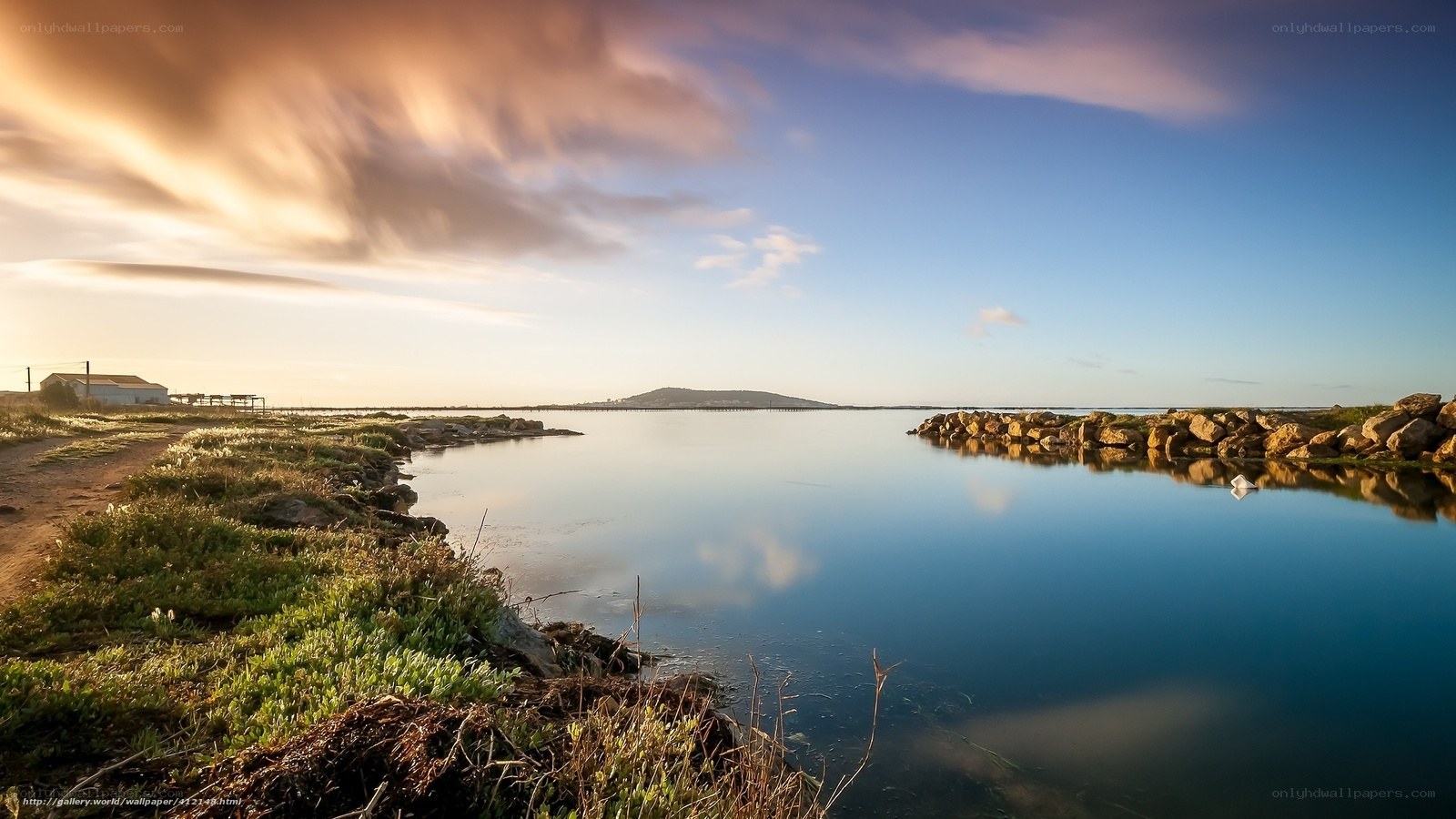 Sunset over a calm coastal inlet