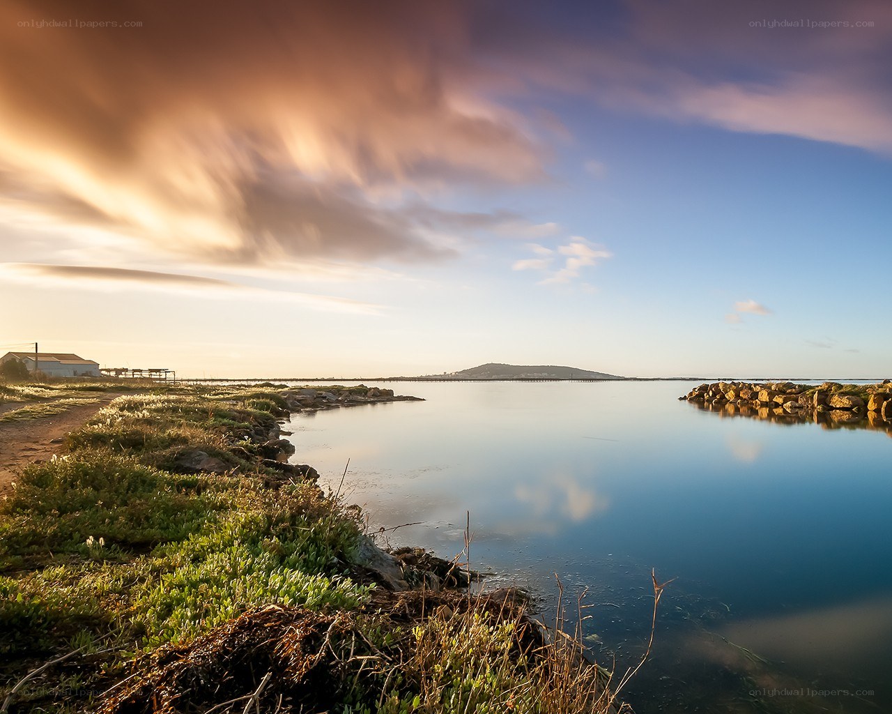 Sunset over a calm coastal lagoon