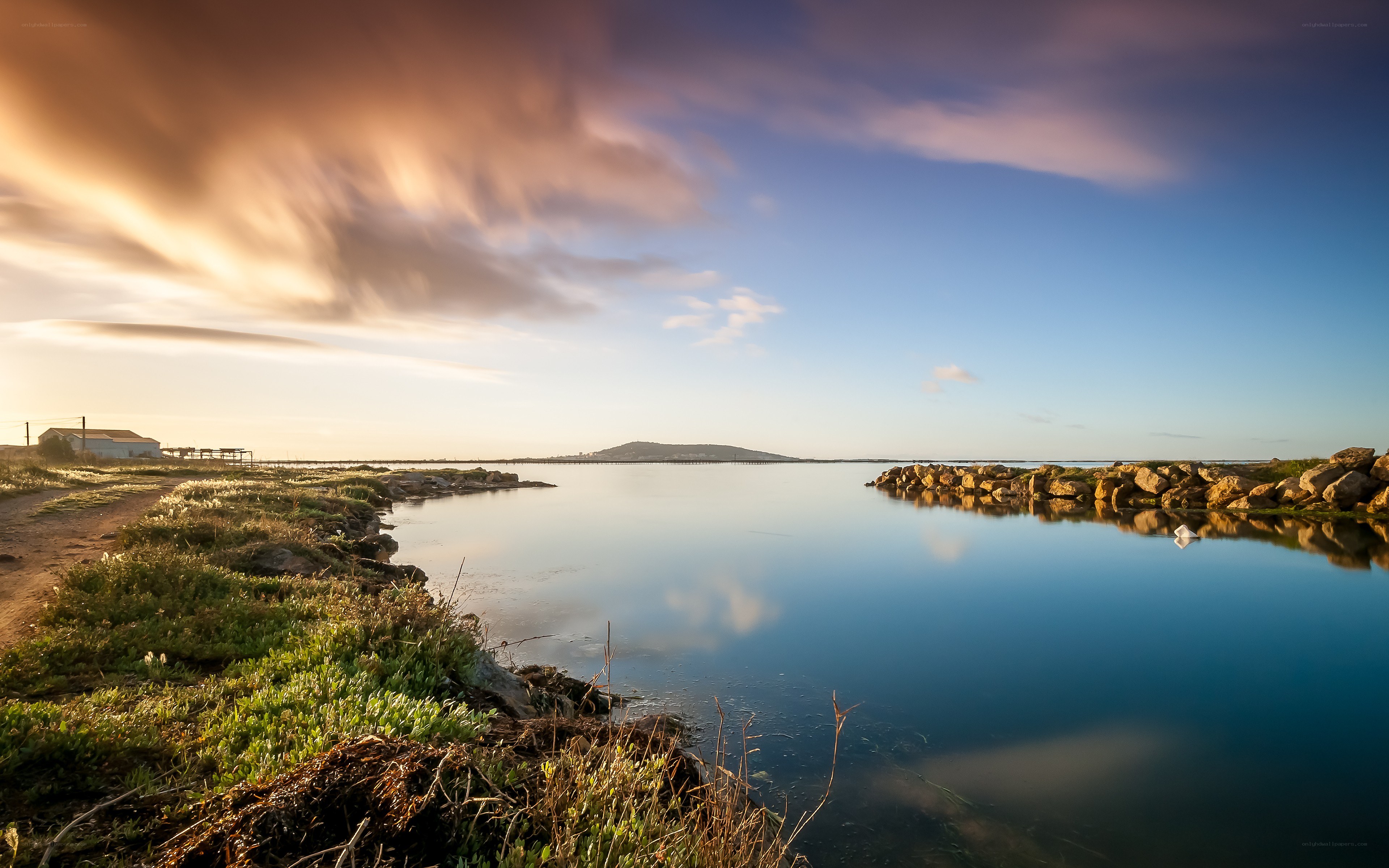 Sunset over a calm coastal lagoon