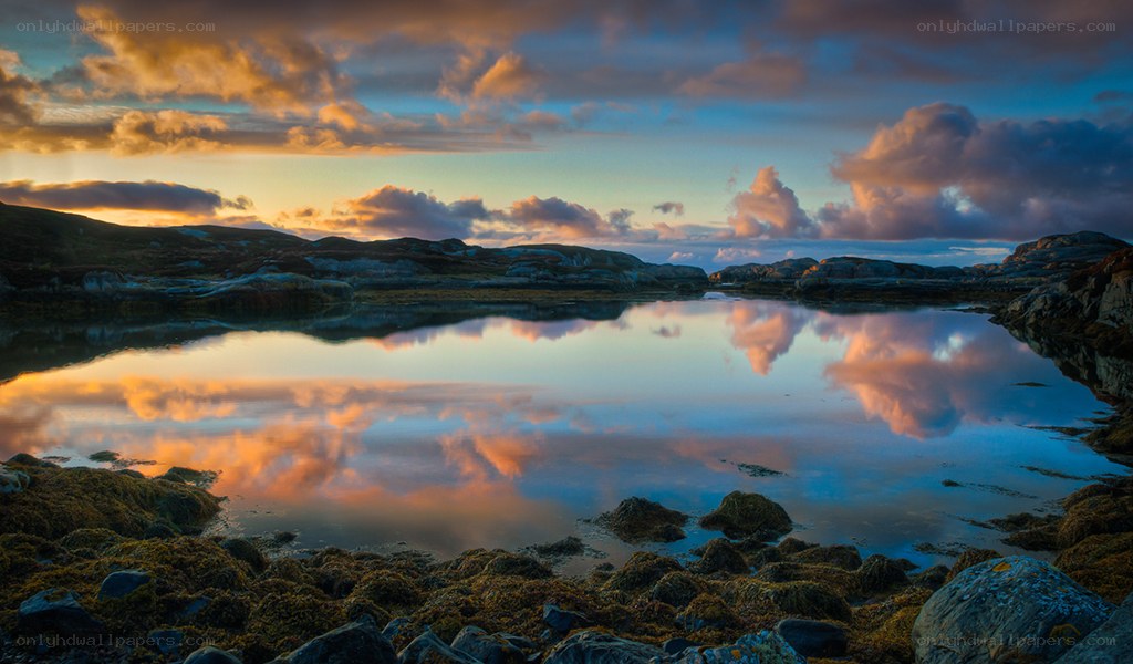 Sunset over a calm coastal pond