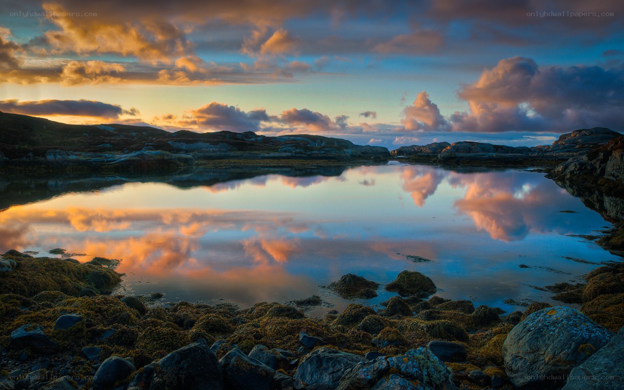 Sunset over a calm coastal pool