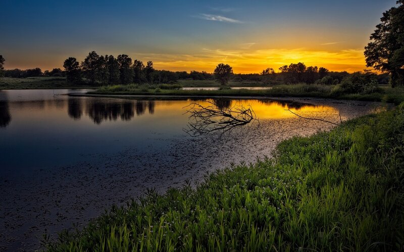 Sunset over a calm pond