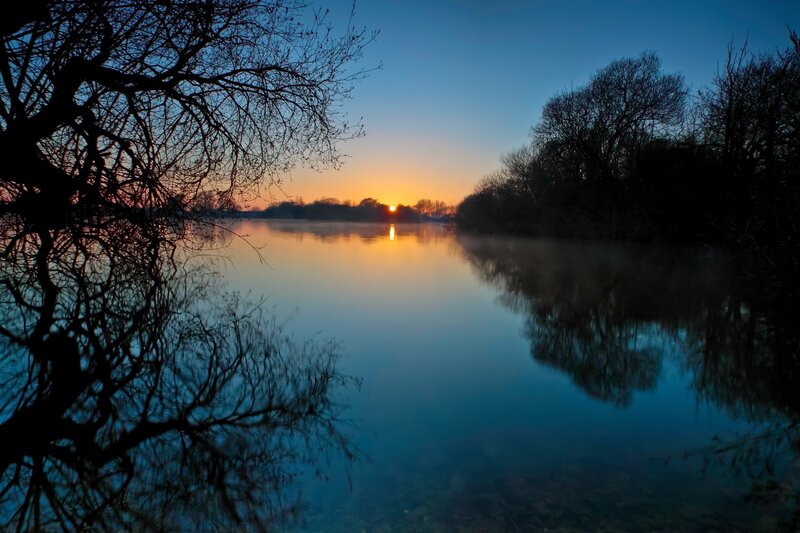 Sunset over a calm river
