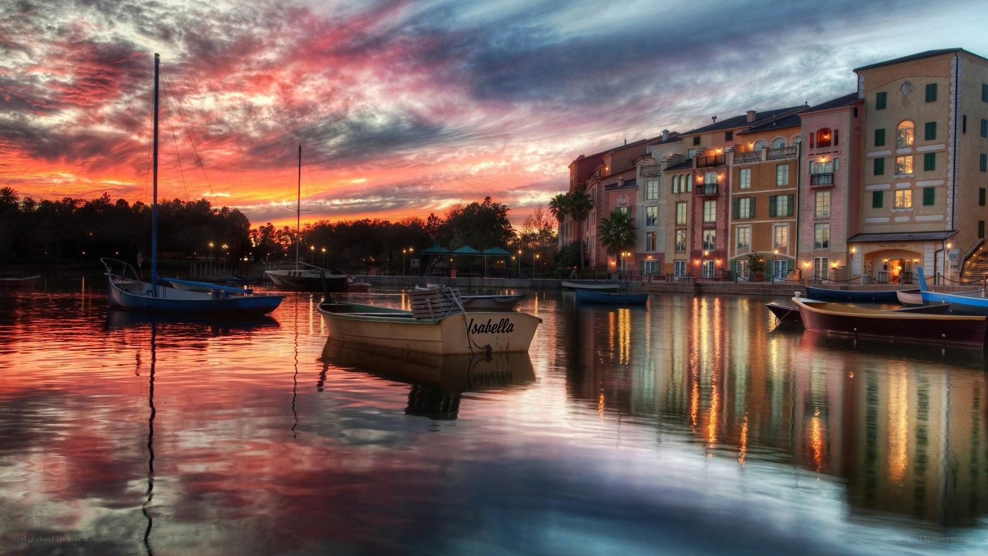 sunset over a canal with boats