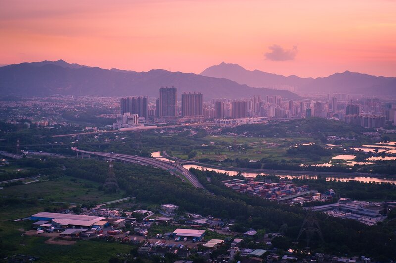 Sunset over a city and mountains