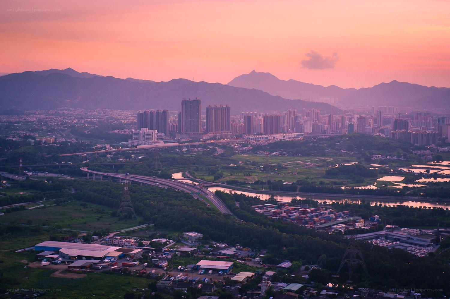 Sunset over a city and mountains
