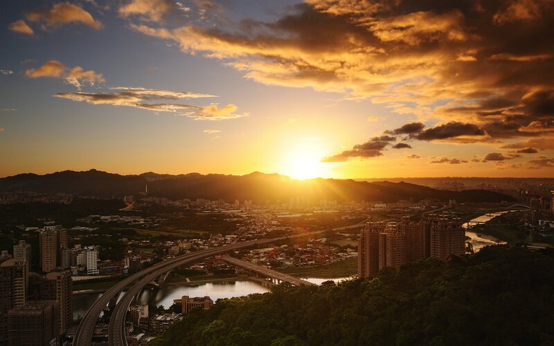 Sunset over a city and river
