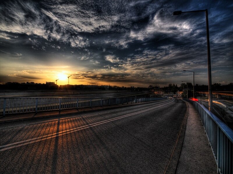 Sunset over a city bridge