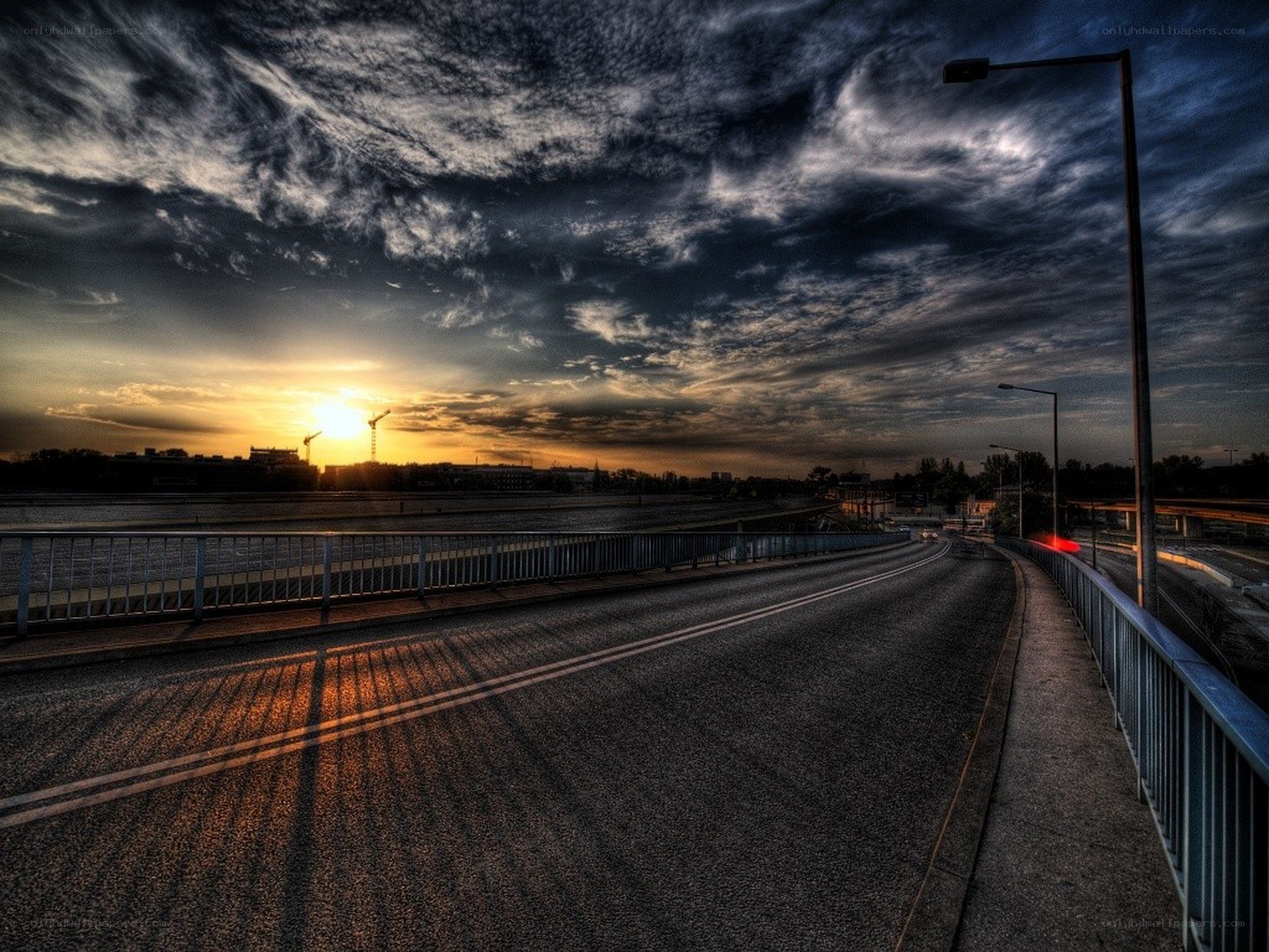 Sunset over a city bridge