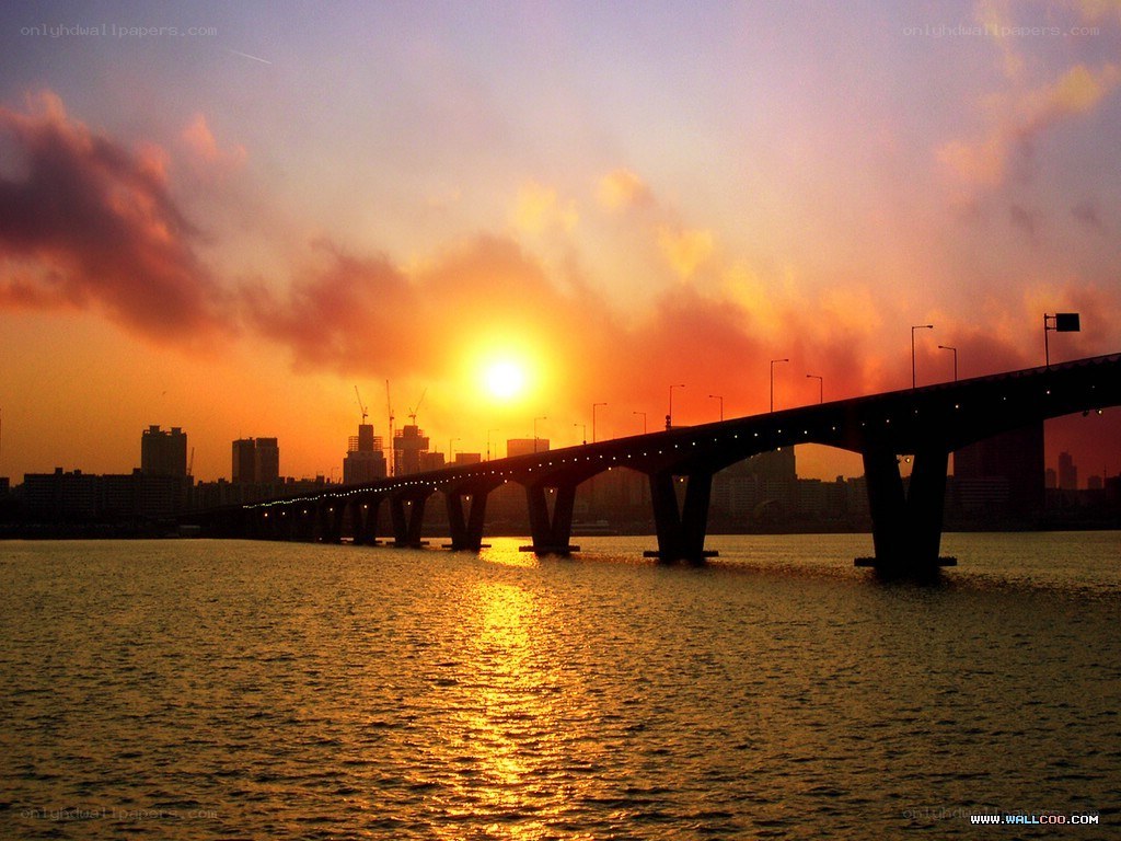 Sunset over a city bridge