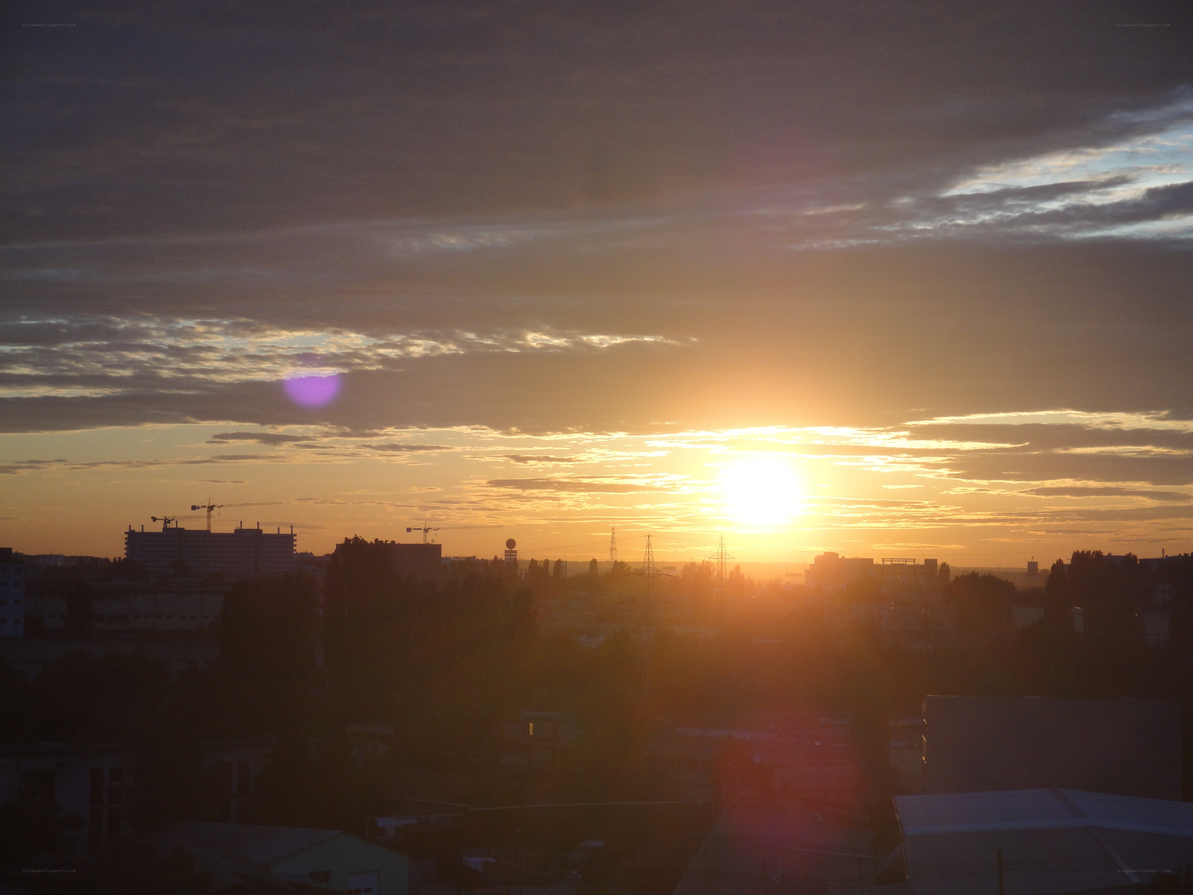 Sunset over a city skyline
