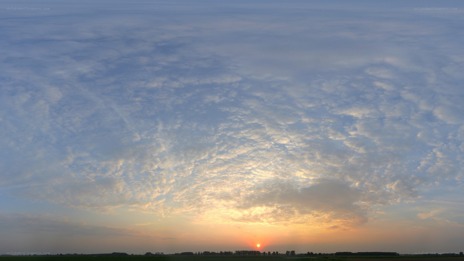 Sunset over a cloudy field