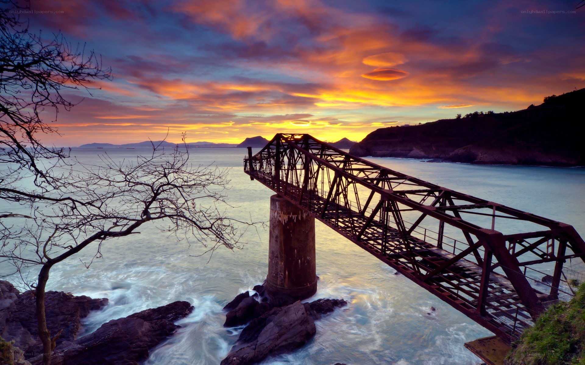 Sunset over a coastal bridge