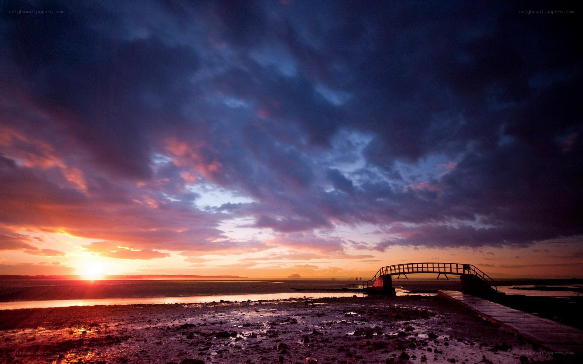 Sunset over a coastal bridge