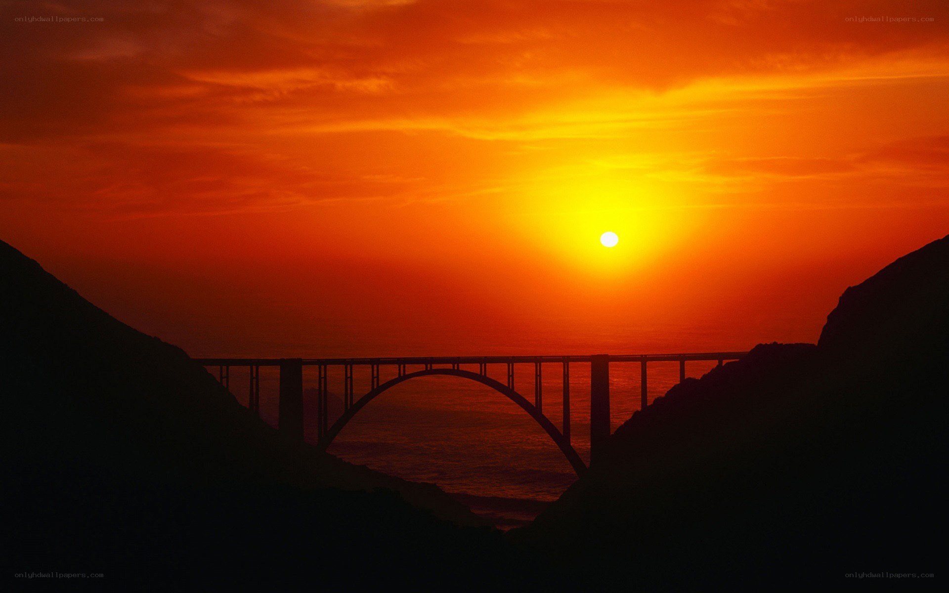 Sunset over a coastal bridge