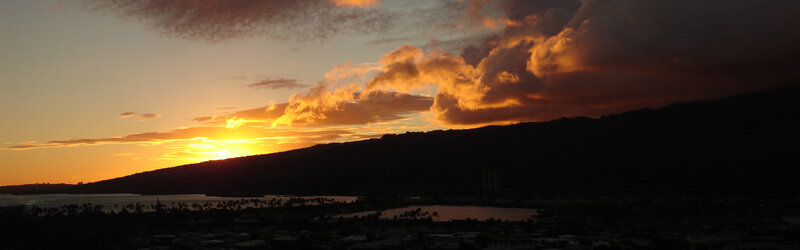 sunset over a coastal mountain