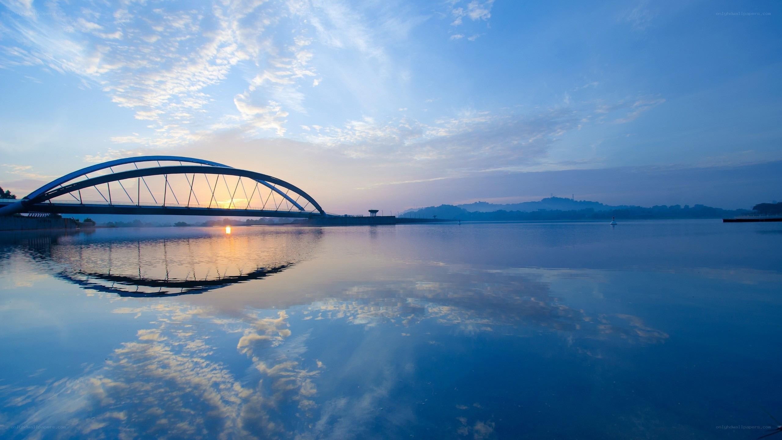 Sunset over a curved bridge