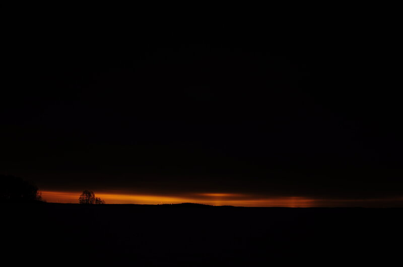 sunset over a dark landscape